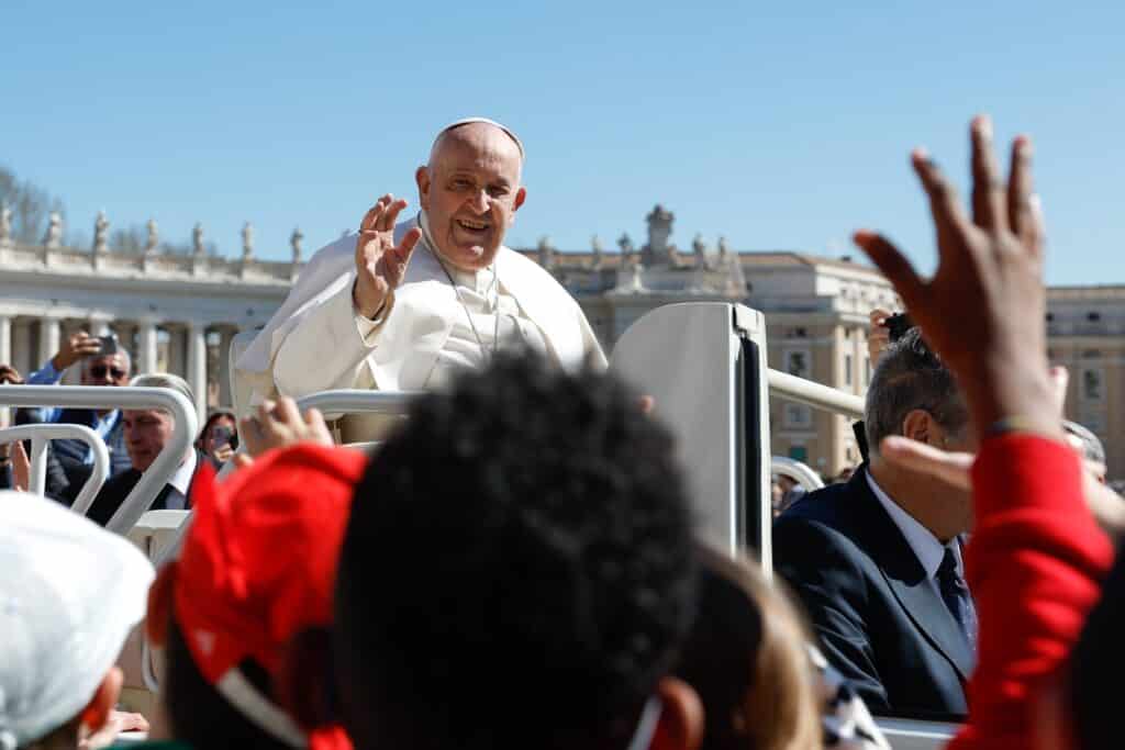 Pope Francis greets children from the popemobile as he leaves St. Peter's Square at the Vatican after his weekly general audience March 20, 2024. A new report released by the Pew Research Center April 12 shows most U.S. Catholics approve of Pope Francis -- but his ratings have slipped in the past few years, marked by political divides. (CNS photo/Lola Gomez)