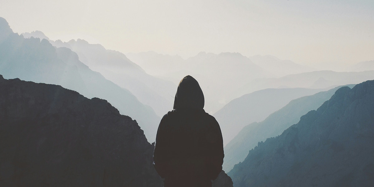 man looking into a valley