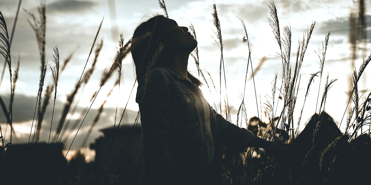 young woman looking up into the sky