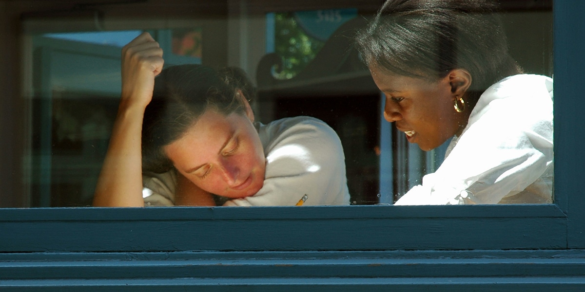 woman tutoring a student and helping with homework