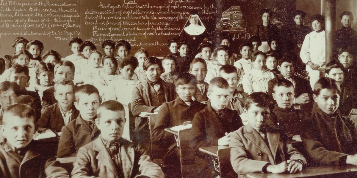 Children sit in a Native American boarding school