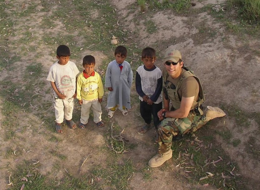Now-Father David Santos is seen with Iraqi children during his time serving in the military in this undated photo. Ordained for the Archdiocese of Newark, N.J., in 2012, Father Santos is pastor of St. James the Apostle Church in Springfield. (OSV News photo/courtesy Father David Santos)