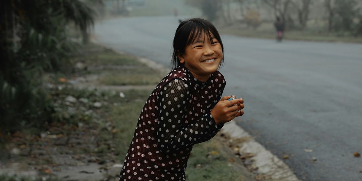 girl being joyful in the midst of a storm.