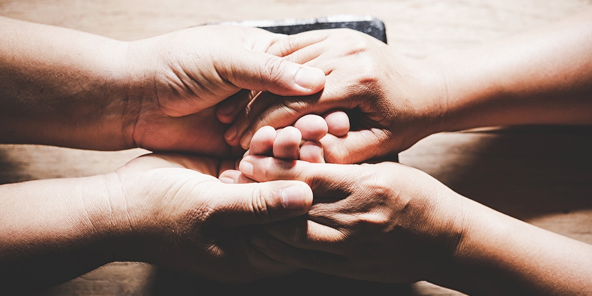 man put hands in his hand as a sign of forgiveness