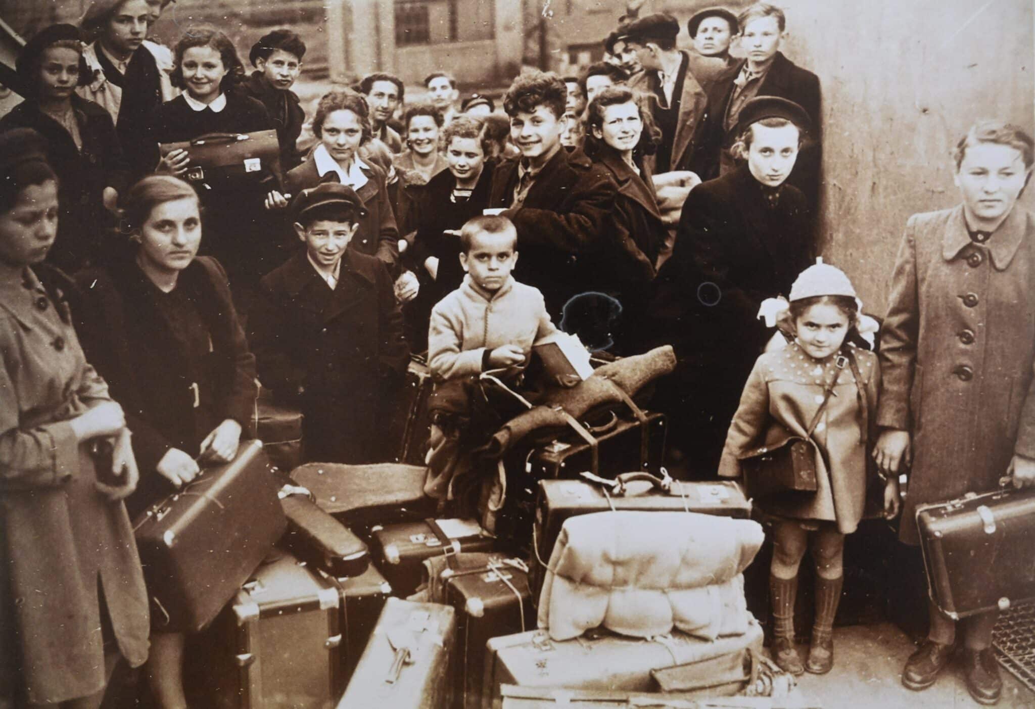 A photo of Holocaust survivor Alex Rosin, 83, born in Poland in 1940, with children on a ship from Poland to England in 1947. He is the boy in the front center with a light jacket. Rosin was saved by living with a Catholic woman in rural Poland. (OSV News photo/Debbie Hill)