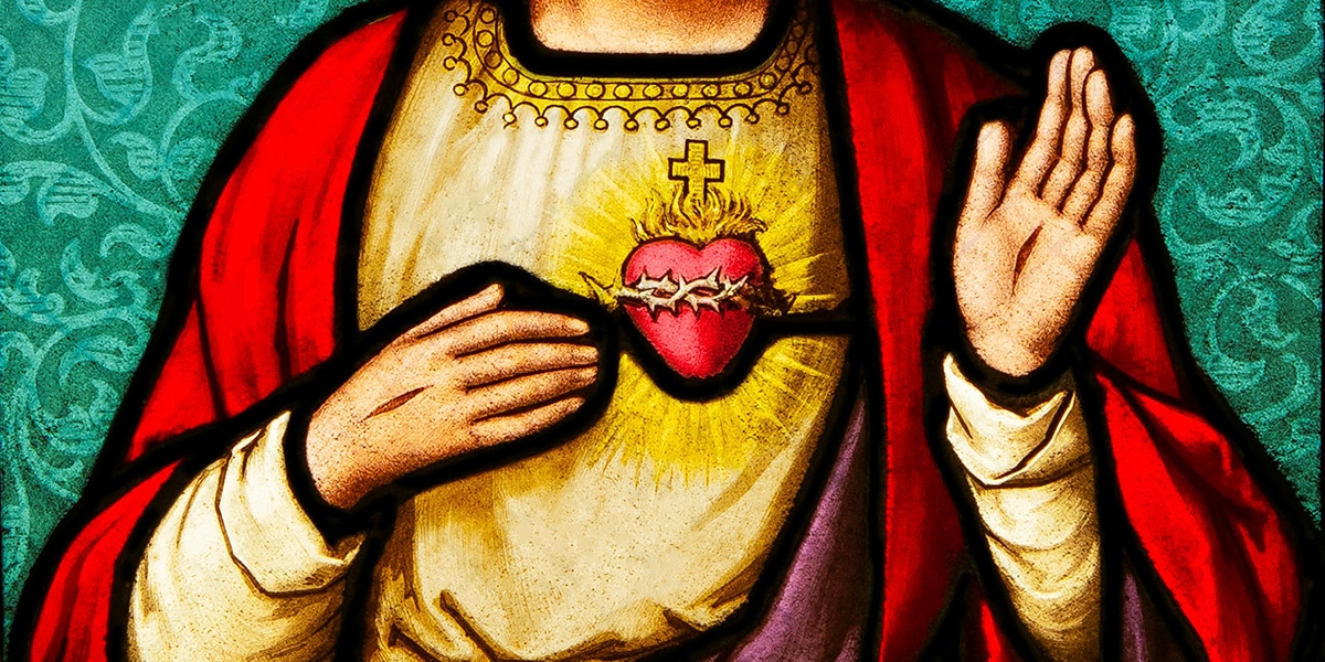 stainless of Jesus pointing at his sacred heart
