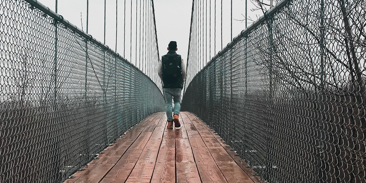 Man crossing a bridge