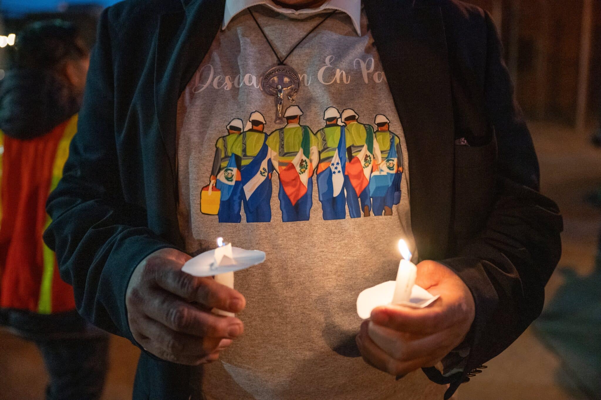 During a prayer service and candlelit procession at Sacred Heart of Jesus/Sagrado Corazón de Jesús in Baltimore April 8, 2024, Manuel Alonso wears a custom shirt with the flags of national origin for the six crewmen who perished in the March 26 collapse of Baltimore's Francis Scott Key Bridge. (OSV News photo/Kevin J. Parks, Catholic Review)