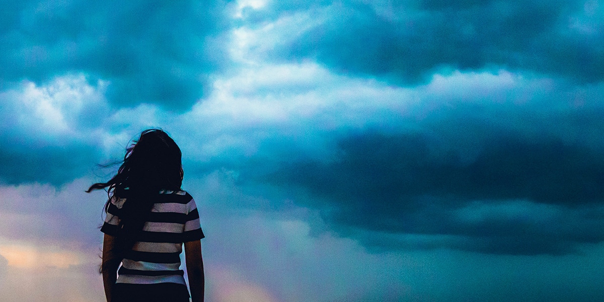 woman watching storm clouds