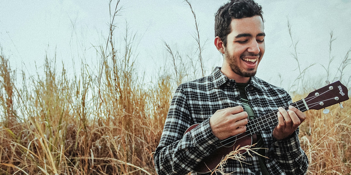 Joyful men playing ukulele
