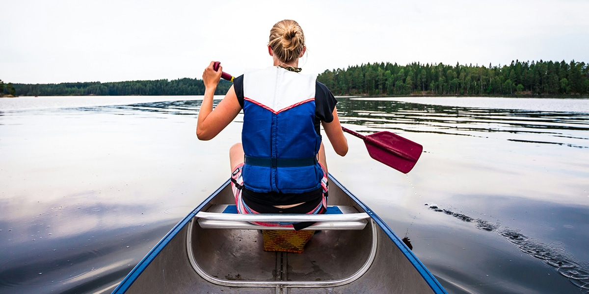 woman paddling in a canoe