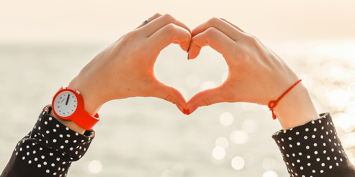 woman forming a heart with her hands