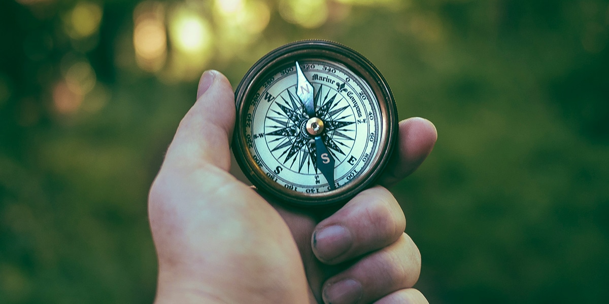 hand holding compass for navigation