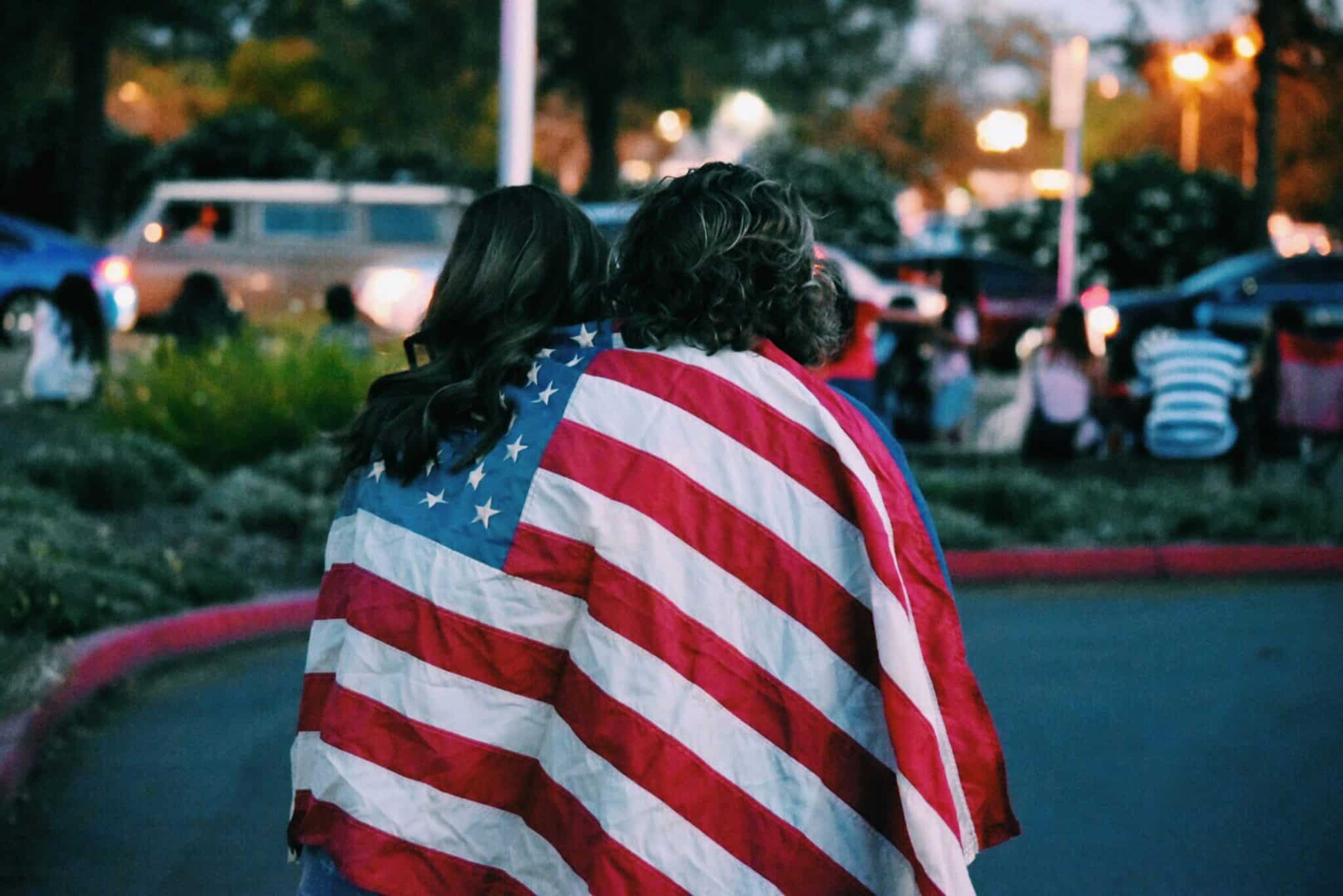 people with a flag | Photo by Courtney Hedger on Unsplash