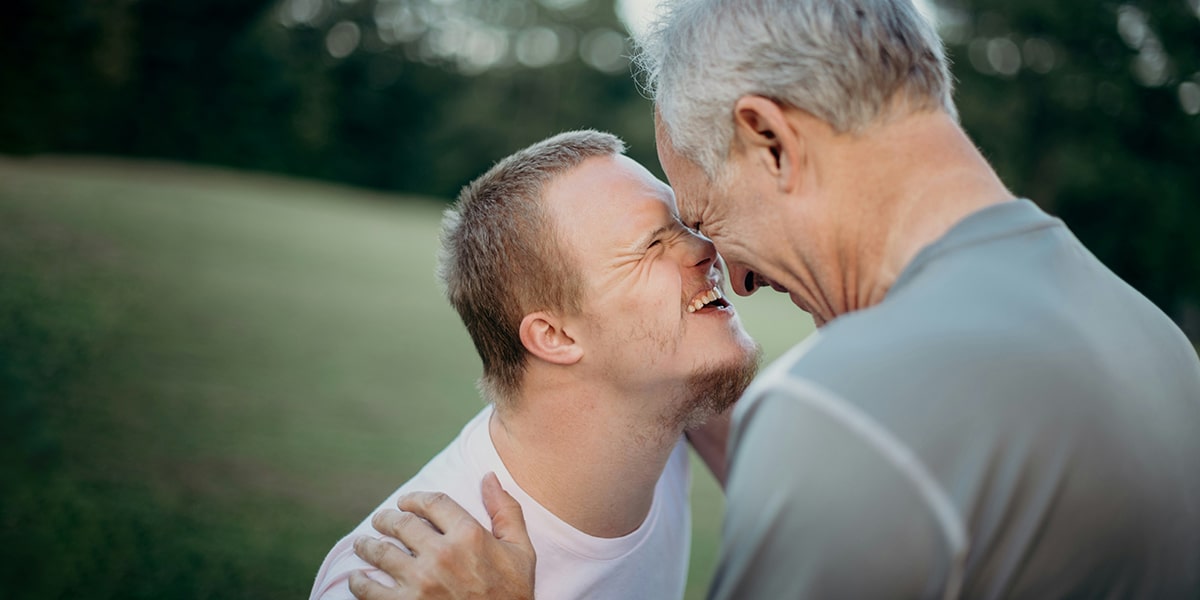 Father enjoying a moment with his son who has Downs Syndrome.