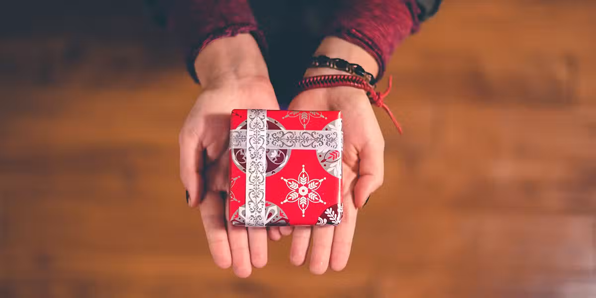 open hands holding a gift to give to someone else.