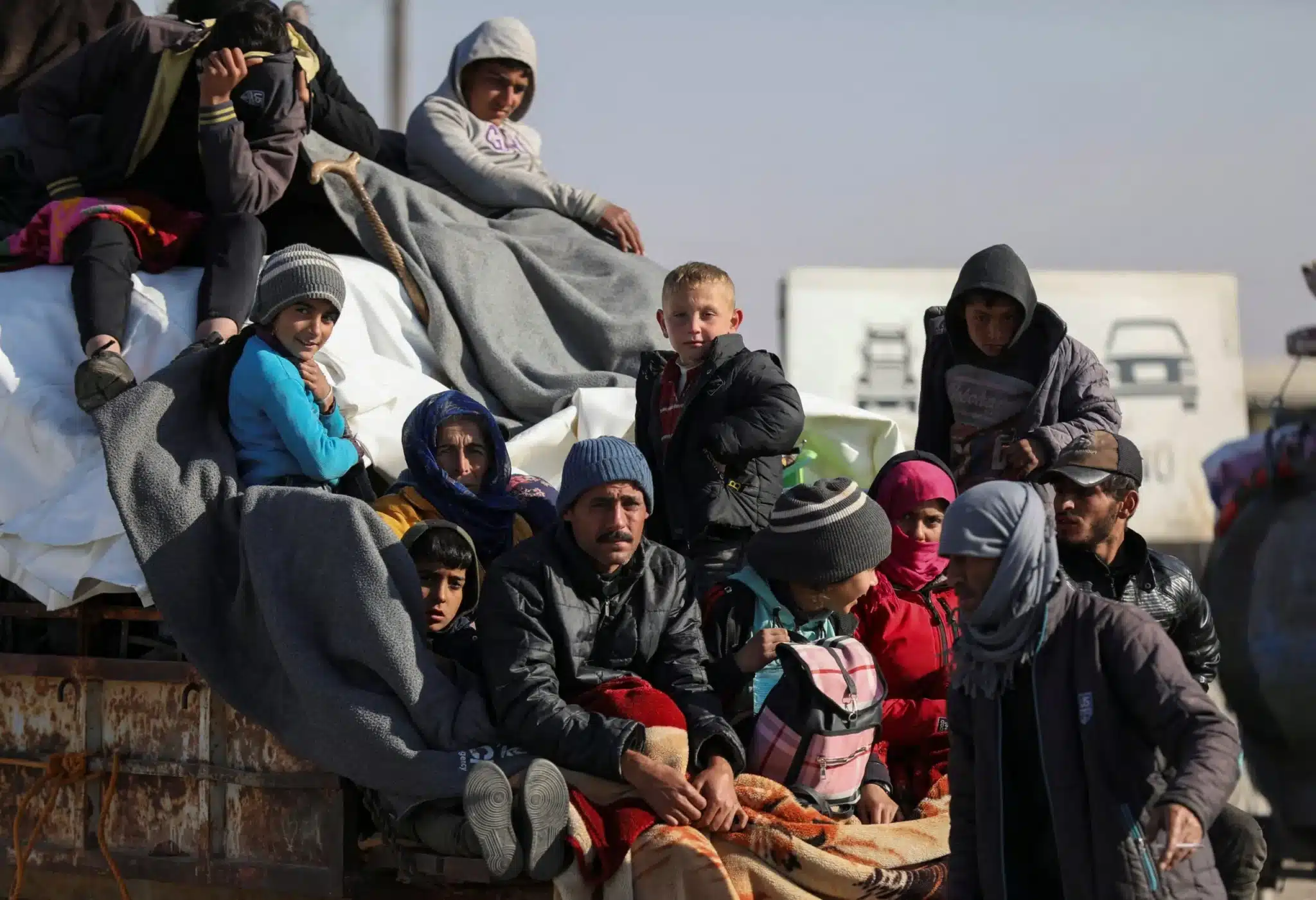 Displaced Syrians who fled from the Aleppo countryside ride on a vehicle with their belongings in Tabqa, Syria, Dec. 3, 2024. (OSV News photo/Orhan Qereman, Reuters)