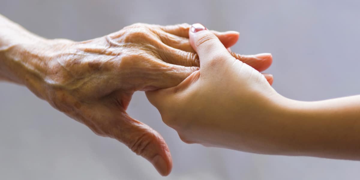 Two people holding hands