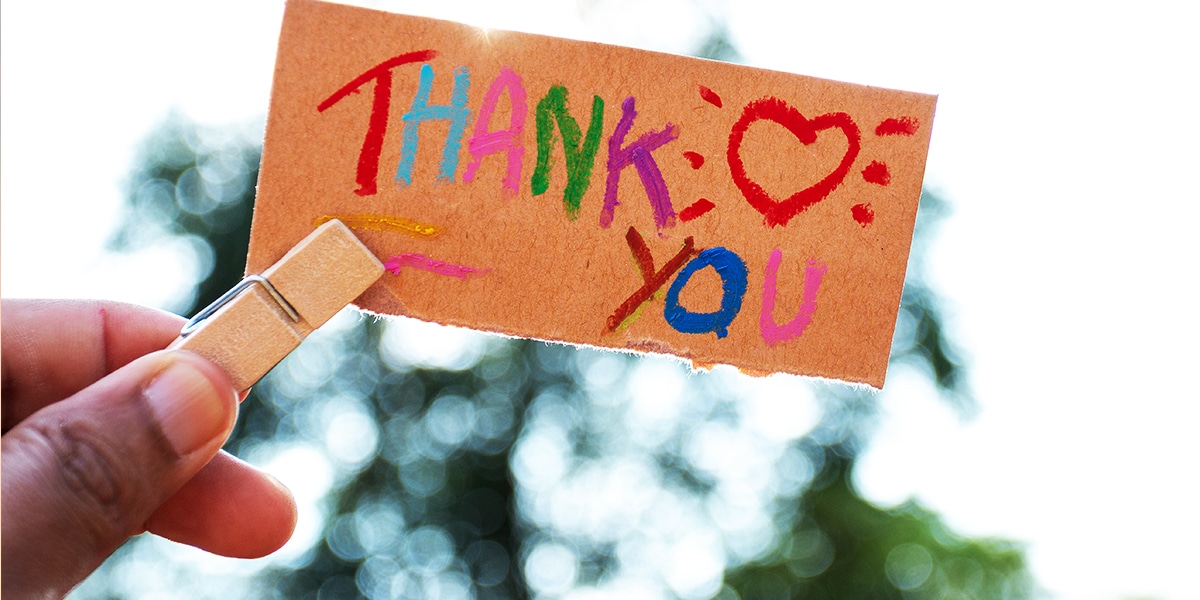 hand holding a gratitude note