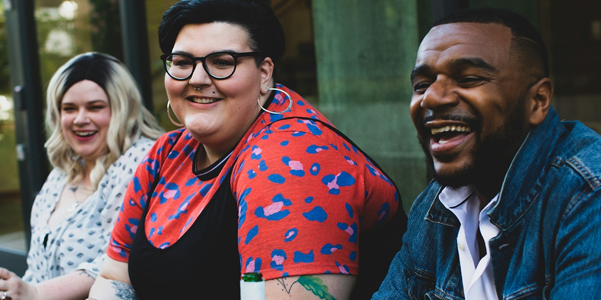three diverse people sitting together
