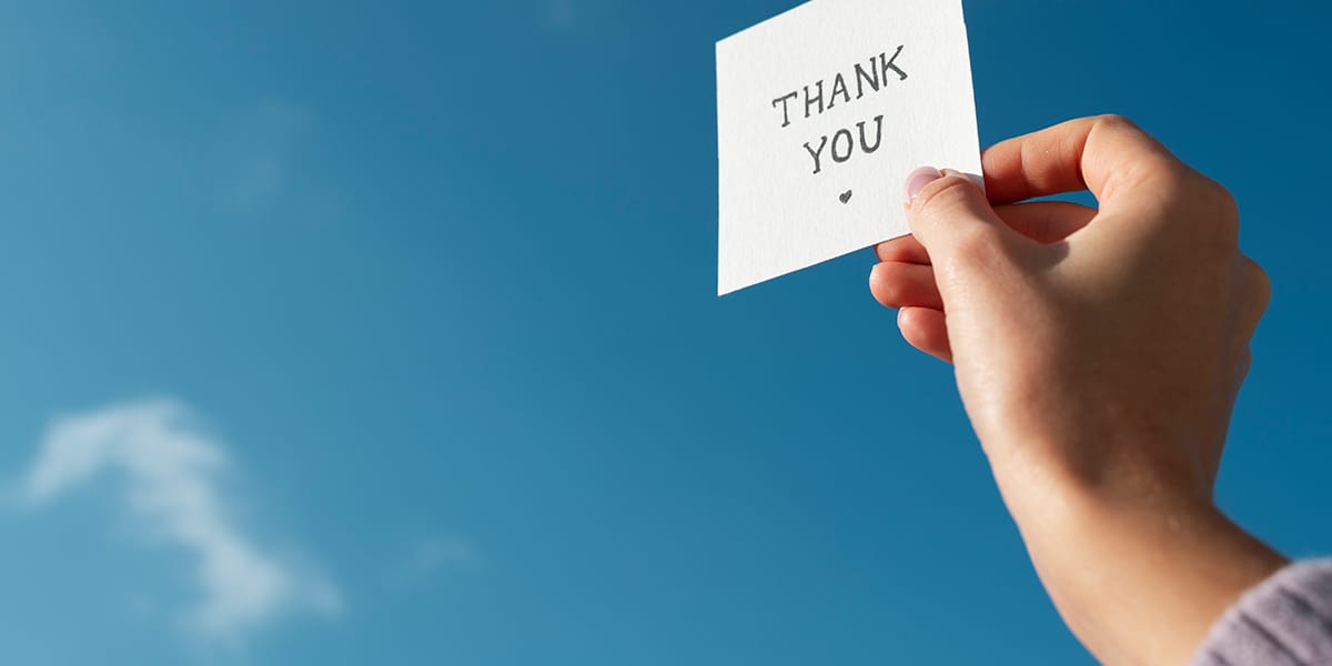 hand holding a thank you note