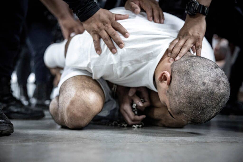Salvadoran police officers escort an alleged member of the Venezuelan gang Tren de Aragua in Tecoluca, El Salvador, March 16, 2025, who were recently deported by the U.S. government to be imprisoned in the Terrorism Confinement Center (CECOT) prison, as part of an agreement with the Salvadoran government. 