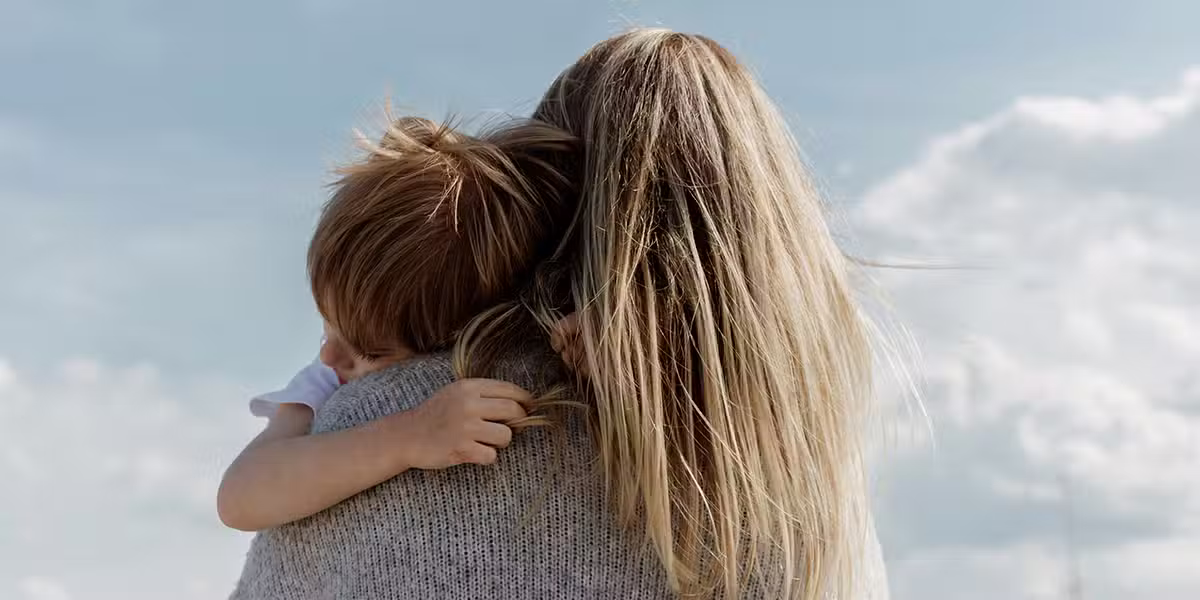 woman holding her son | Photo by Bethany Beck on Unsplash