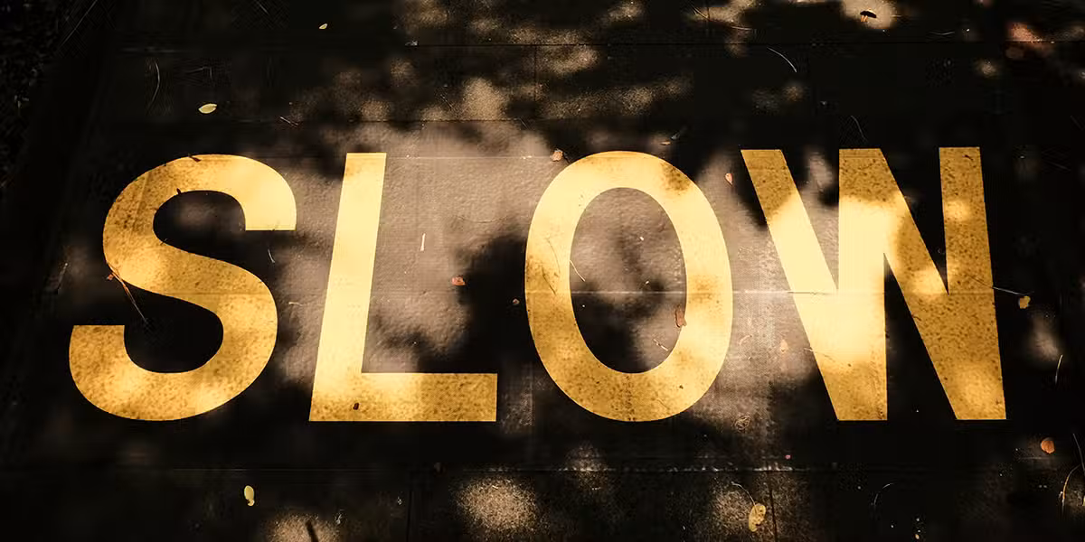 The word "SLOW" painted on the pavement