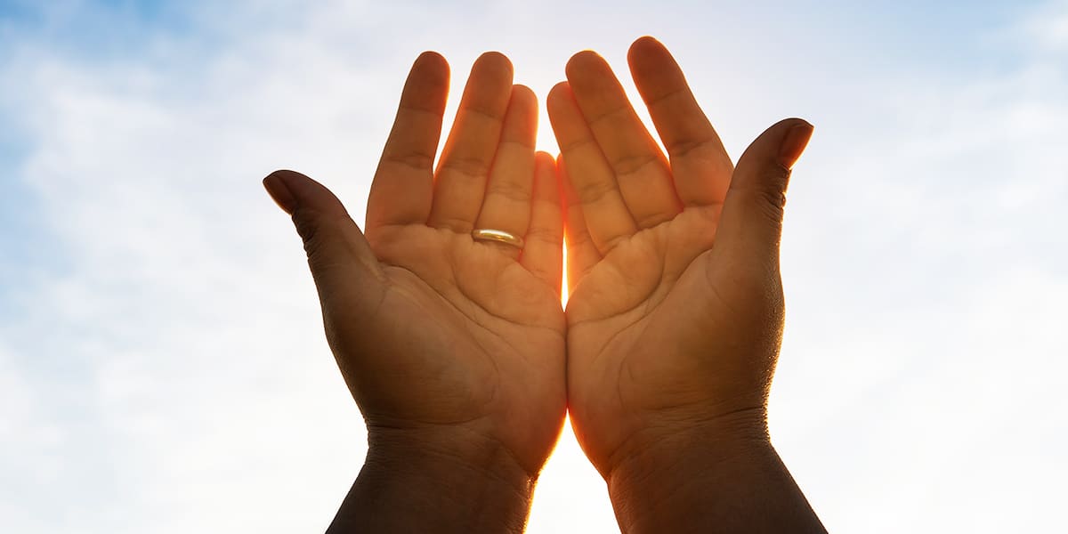 open hands in a gesture of receiving and surrendering