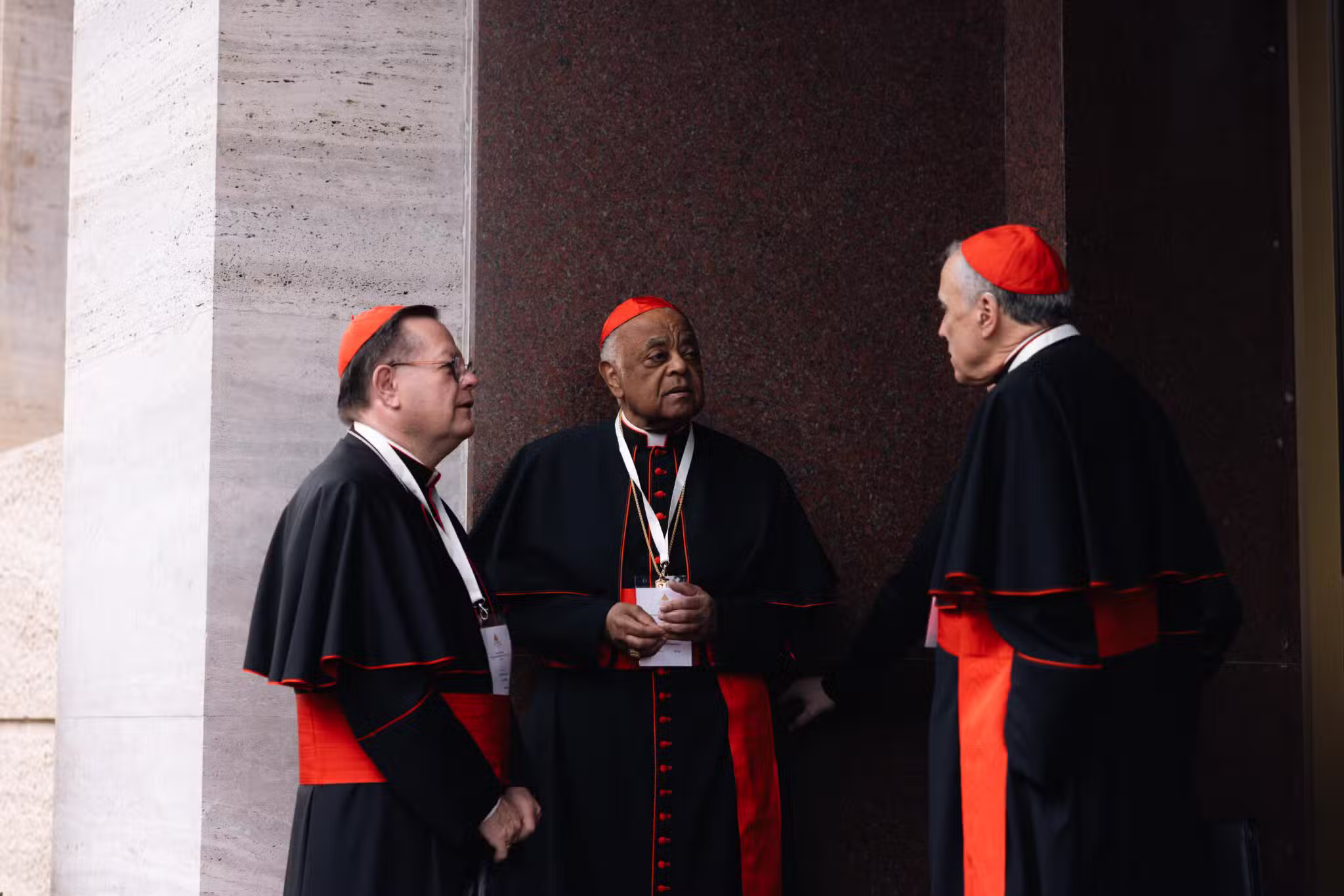 Cardinals Gérald C. Lacroix of Québec, Wilton D. Gregory, retired archbishop of Washington, and Daniel N. DiNardo, retired archbishop of Galveston-Houston, speak outside the Pontifical North American College in Rome May 5, 2025.