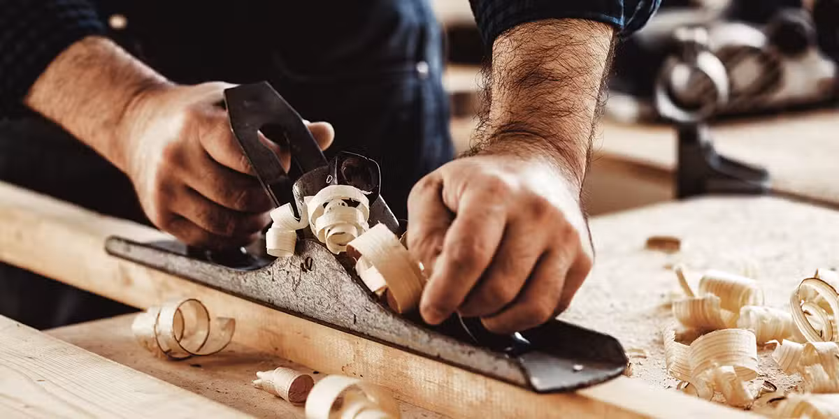 carpenter working in his wood shop on wood.