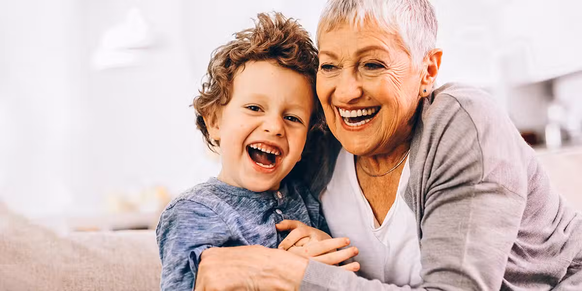 grandmother and grandson laughing together.