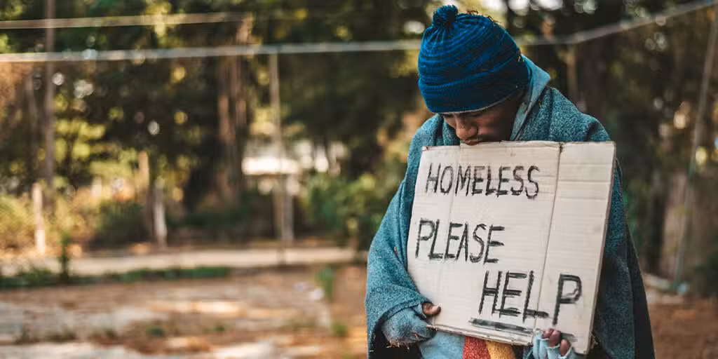 A homeless man with a sign.