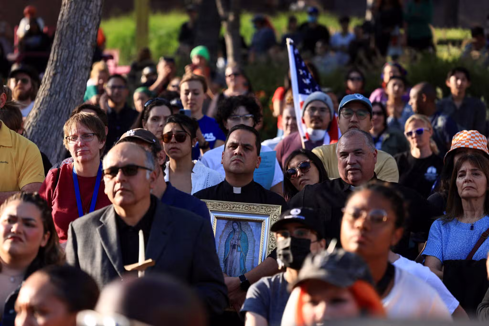 A member of the clergy holding an image of Our Lady of Guadalupe attends a vigil in Grand Park in downtown Los Angeles June 10, 2025, as protests against federal immigration sweeps continue.