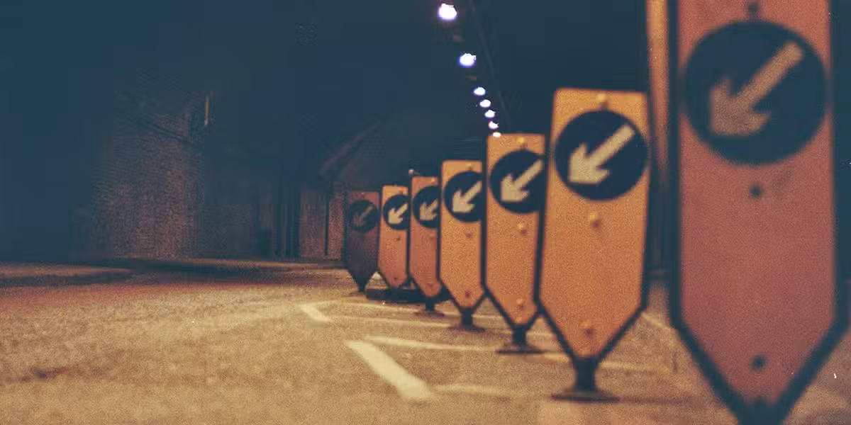 signs with arrows showing a detour and interruption of traffic flow