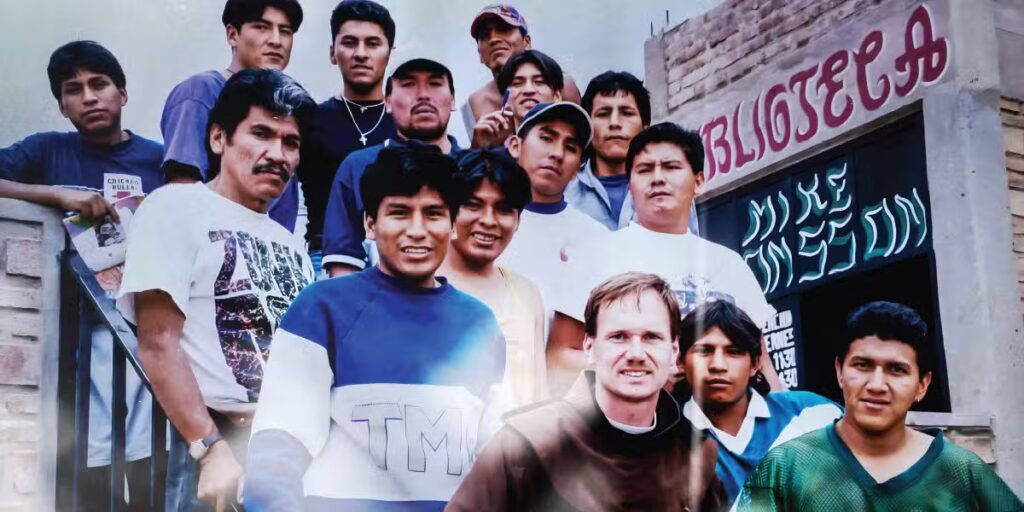Brother Mike Johnson, OFM, wearing his Franciscan habit, smiles with a group of inmates at El Abra after finishing the construction of a
learning center. The center includes a library and a classroom, allowing some of the inmates to obtain
the equivalent of a GED while in prison.