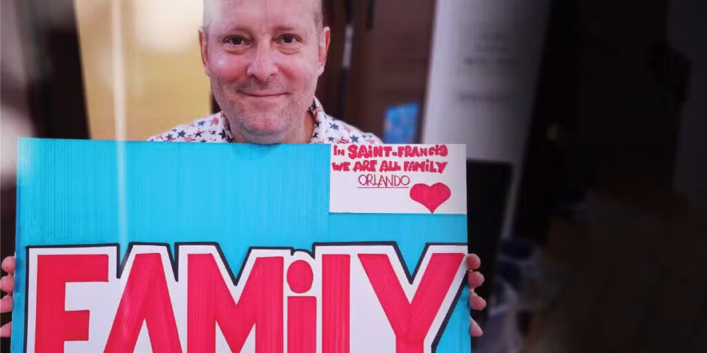 Man holds up a sign