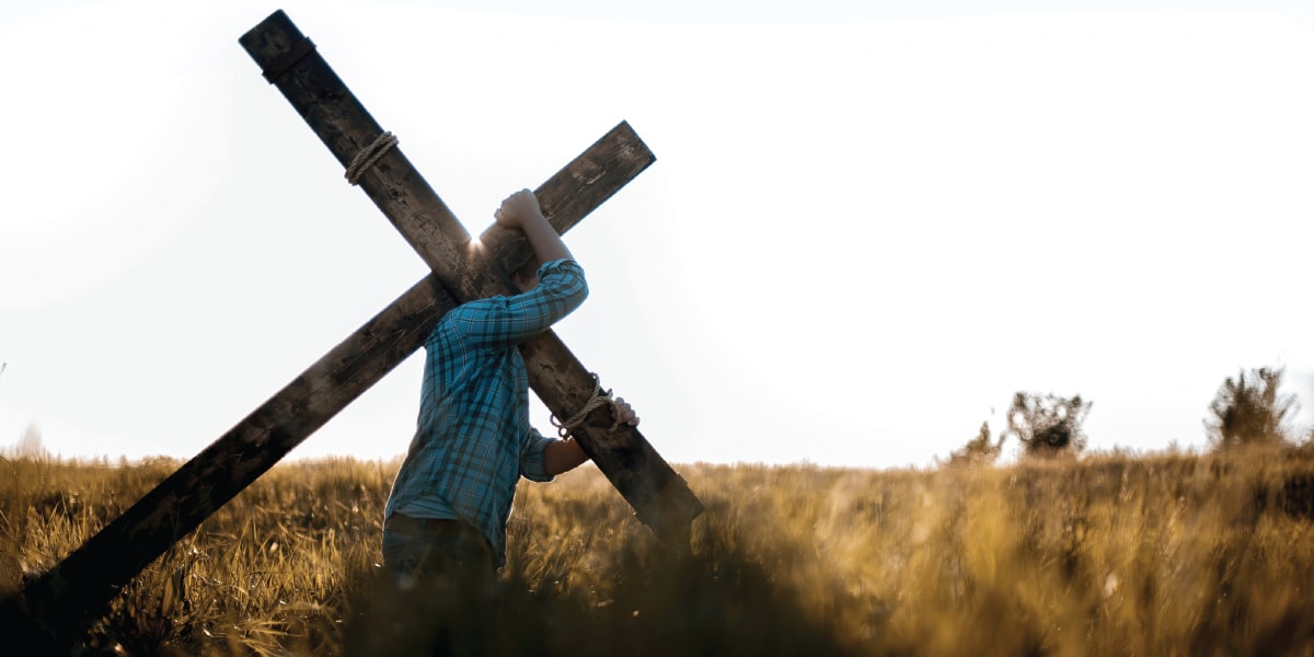Person carrying cross