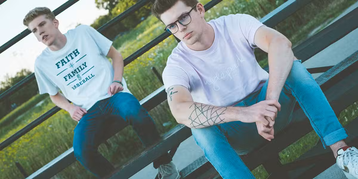 two guys sitting on bleachers