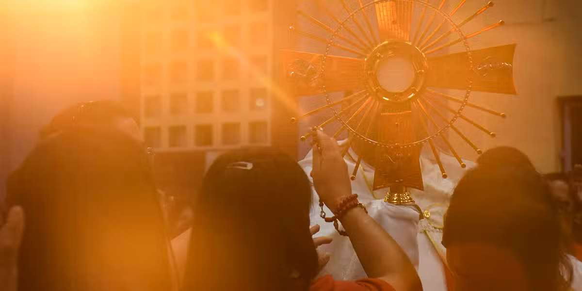 woman in a church with light shining on the eucharist