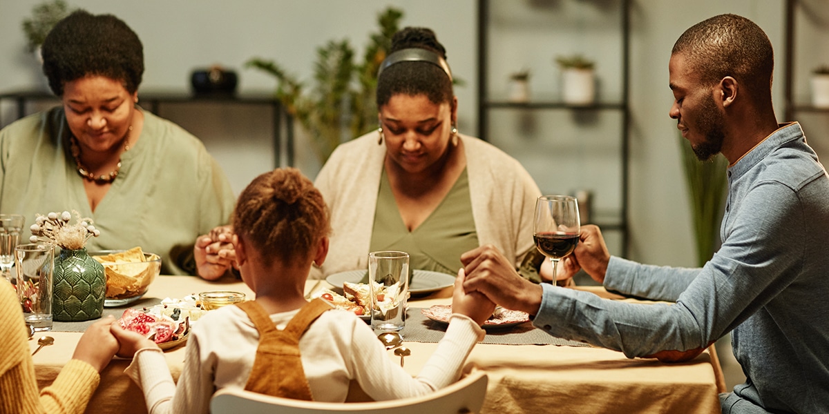 A family praying before dinner
