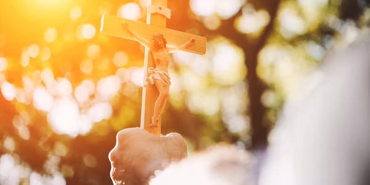 hand holding a cross