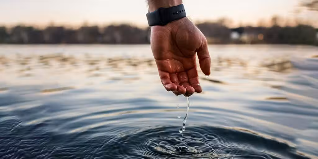 drops of water dripping from a hand dipped in water