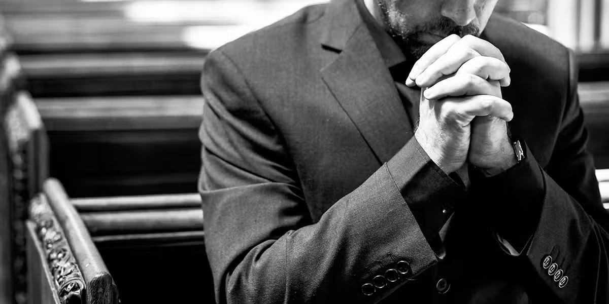 man praying in a church.