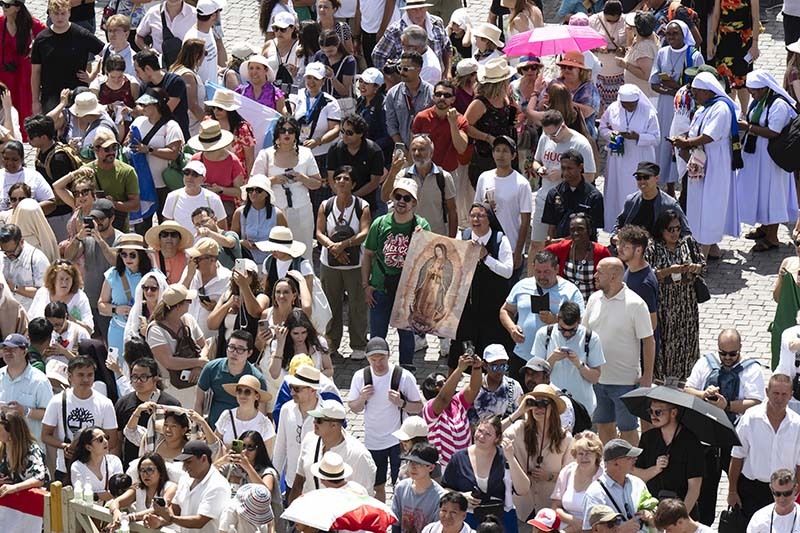 Visitors hold an image of Our Lady of Guadalupe as they gather in St. Peter’s Square at the Vatican for the Angelus with Pope Leo XIV July 27, 2025. (CNS photo/Vatican Media)