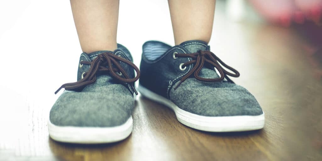 toddler wearing adult shoes.