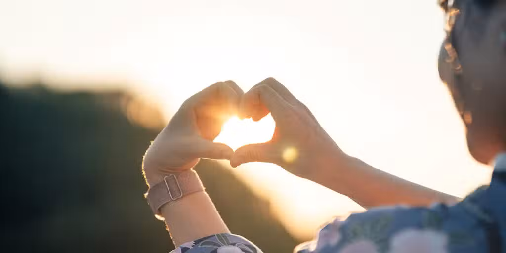 woman forming a heart with her hands
