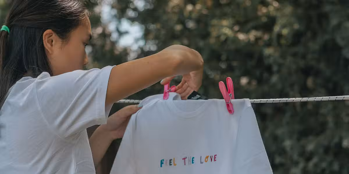 woman putting clothes on a laundry line.
