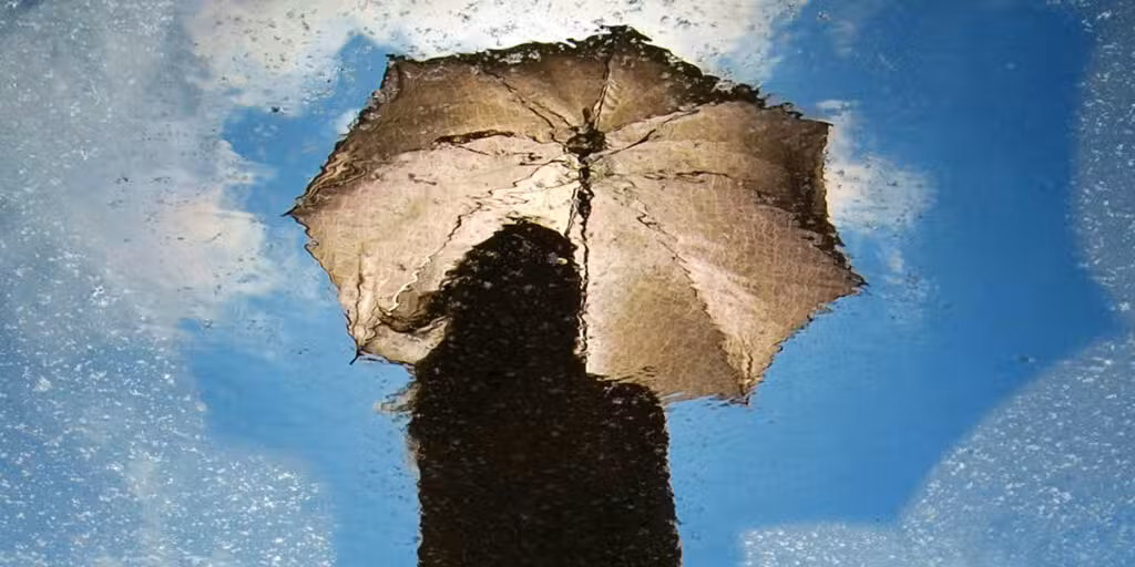 reflection of a woman under a umbrella