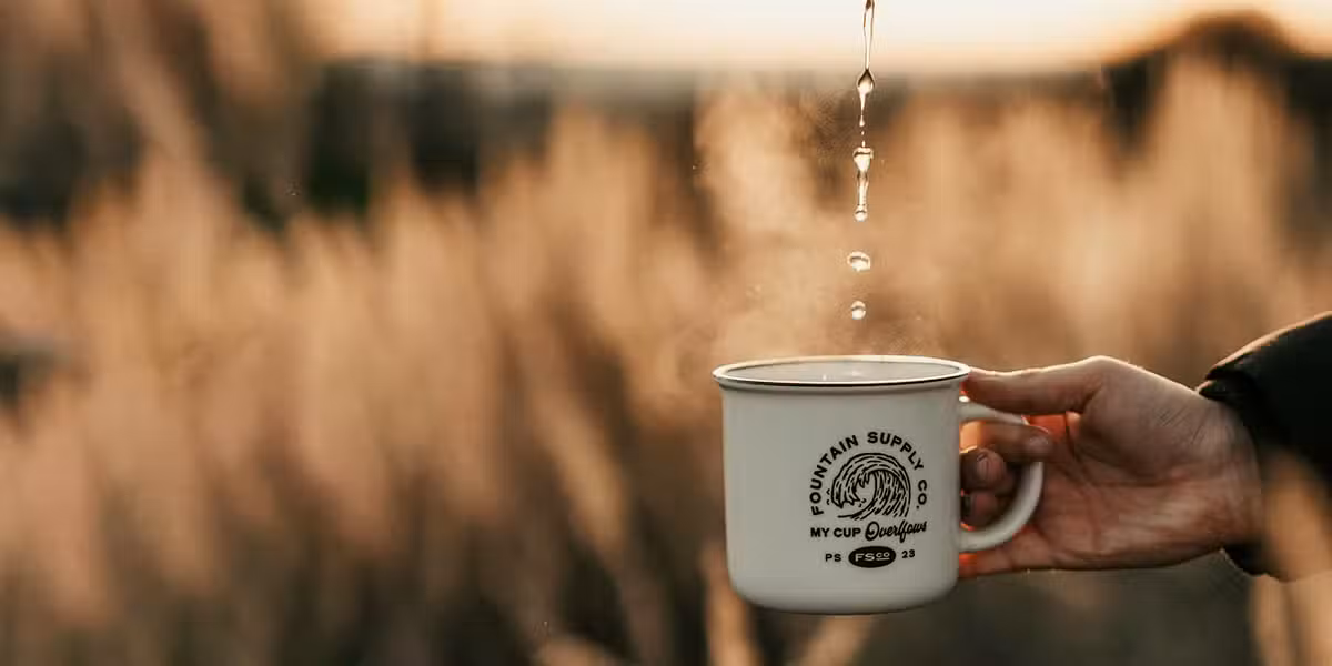 hand holding cup that is being refilled